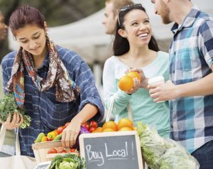 A group of people shopping at a farmers' market in Bluffton.