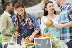 A group of people shopping at a farmers' market near Apartments in Bluffton.