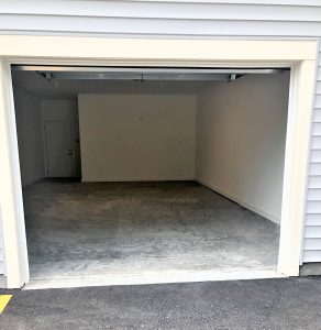 Apartments with a garage and a concrete floor.