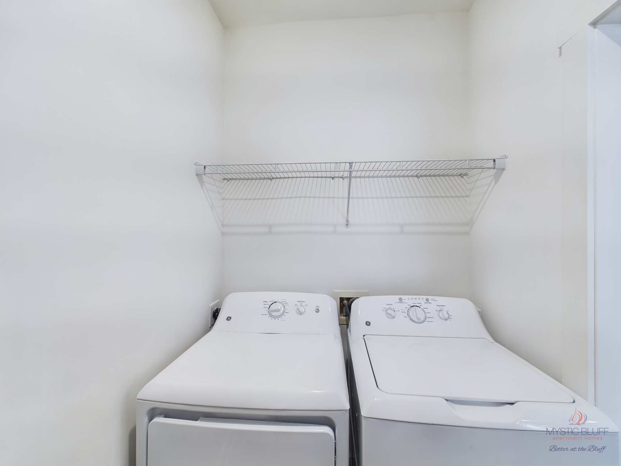 One Bedroom Apartments: A laundry room with two washers and dryers.