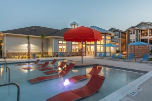Apartments for rent in Bluffton, SC - Pools with Tanning Shelf and Patio Area at Dusk      