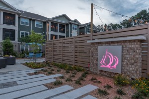 Apartments for rent in Bluffton, South Carolina - Patio and Pathway with Lighted Sign at Dusk