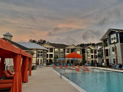 Apartment Rentals in Bluffton, South Carolina - Swimming Pool and Patio Area with Cabanas at Dusk